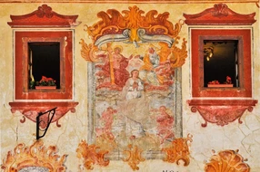 Renovated fresco between ornamental windows. Bardejov, Slovakia - UNESCO World Heritage town.